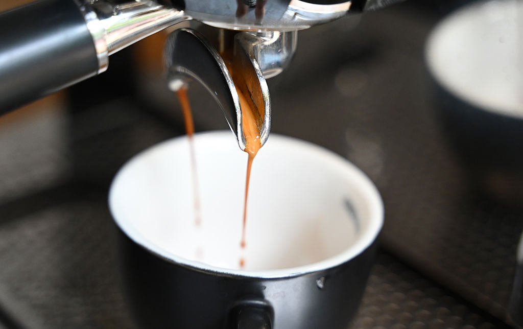 Superautomática o cápsulas: espresso cayendo en una taza